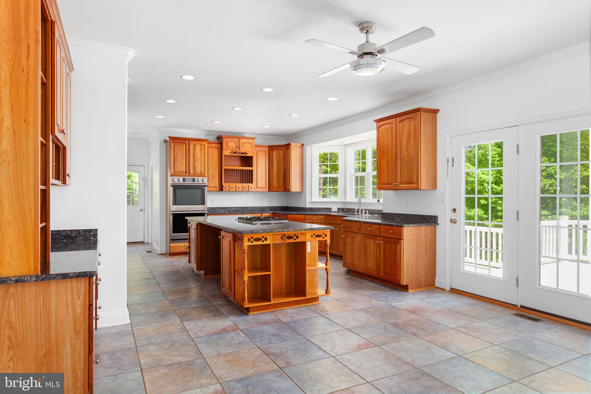 70 Sentinel Ridge Lane Stafford, VA 22554 - Photo 12 of 53 a large kitchen with stainless steel appliances granite countertop a stove a sink and a refrigerator