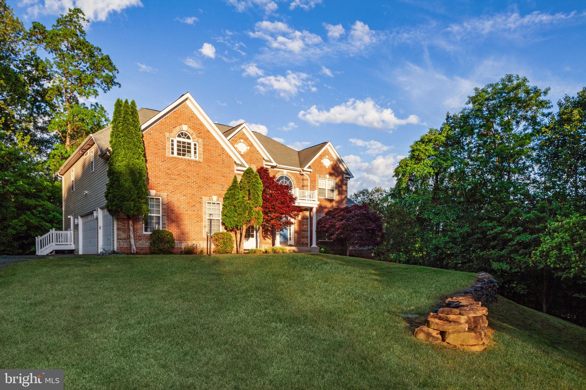 70 Sentinel Ridge Lane Stafford, VA 22554 - Photo 2 of 53 a front view of a house with a garden and trees