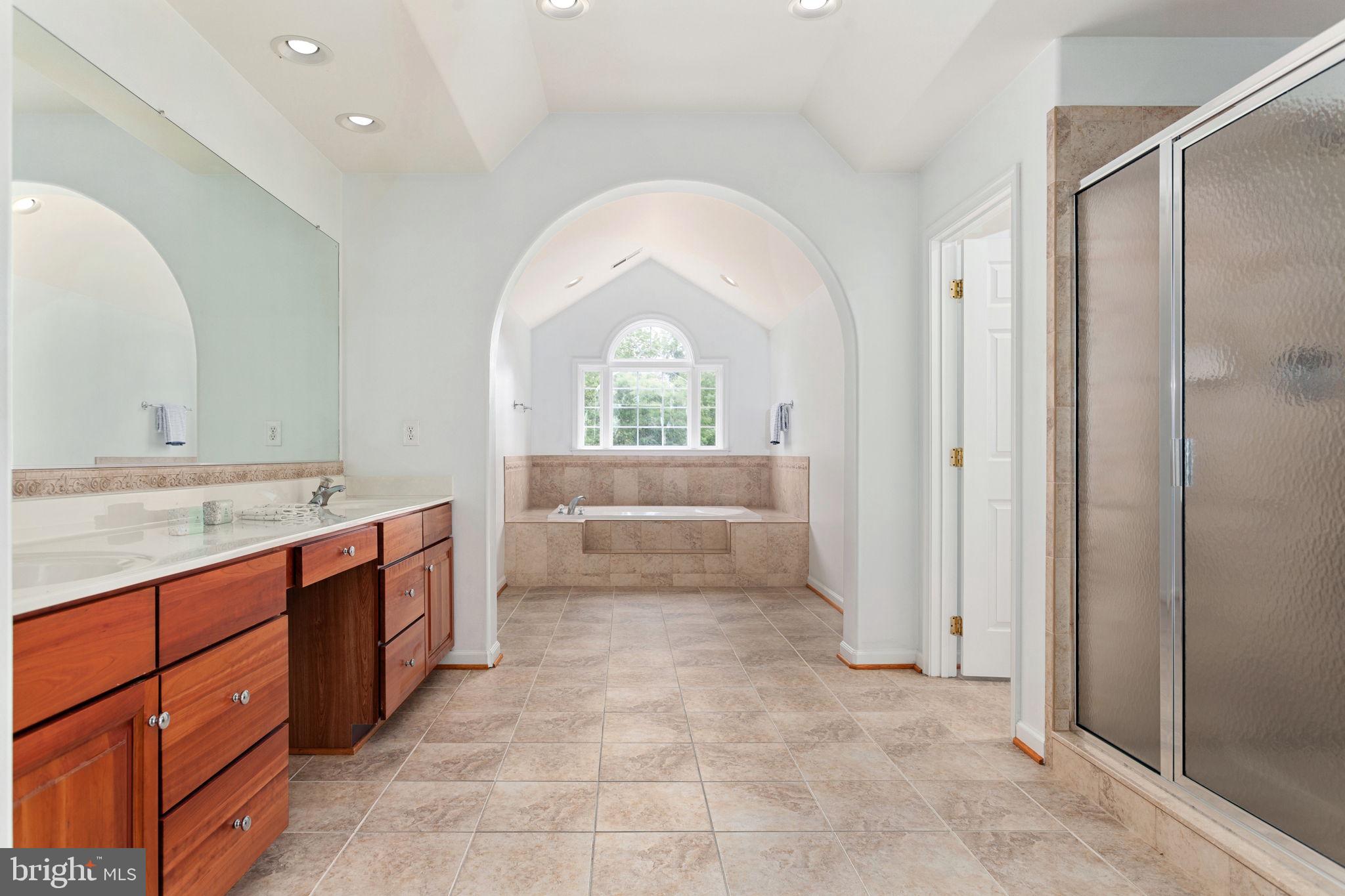 70 Sentinel Ridge Lane Stafford, VA 22554 - Photo 27 of 53 a large bathroom with a granite countertop sink a mirror and a bathtub