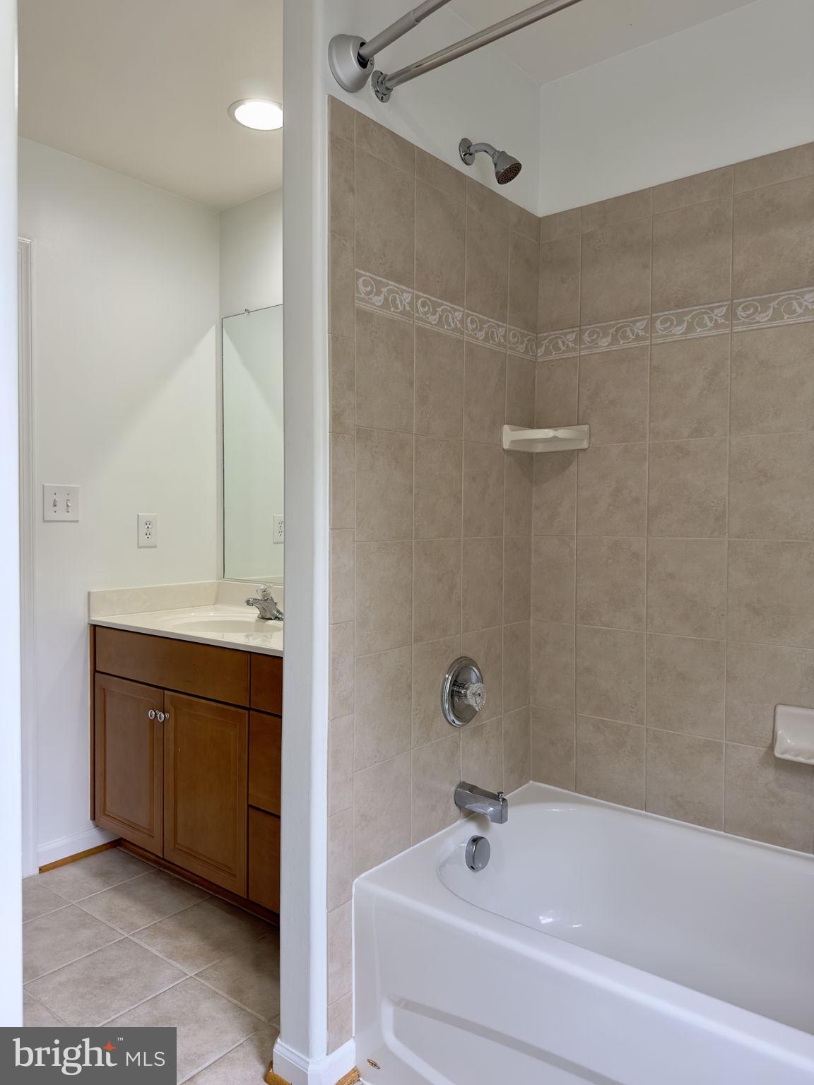70 Sentinel Ridge Lane Stafford, VA 22554 - Photo 34 of 53 a bathroom with a tub sink and mirror