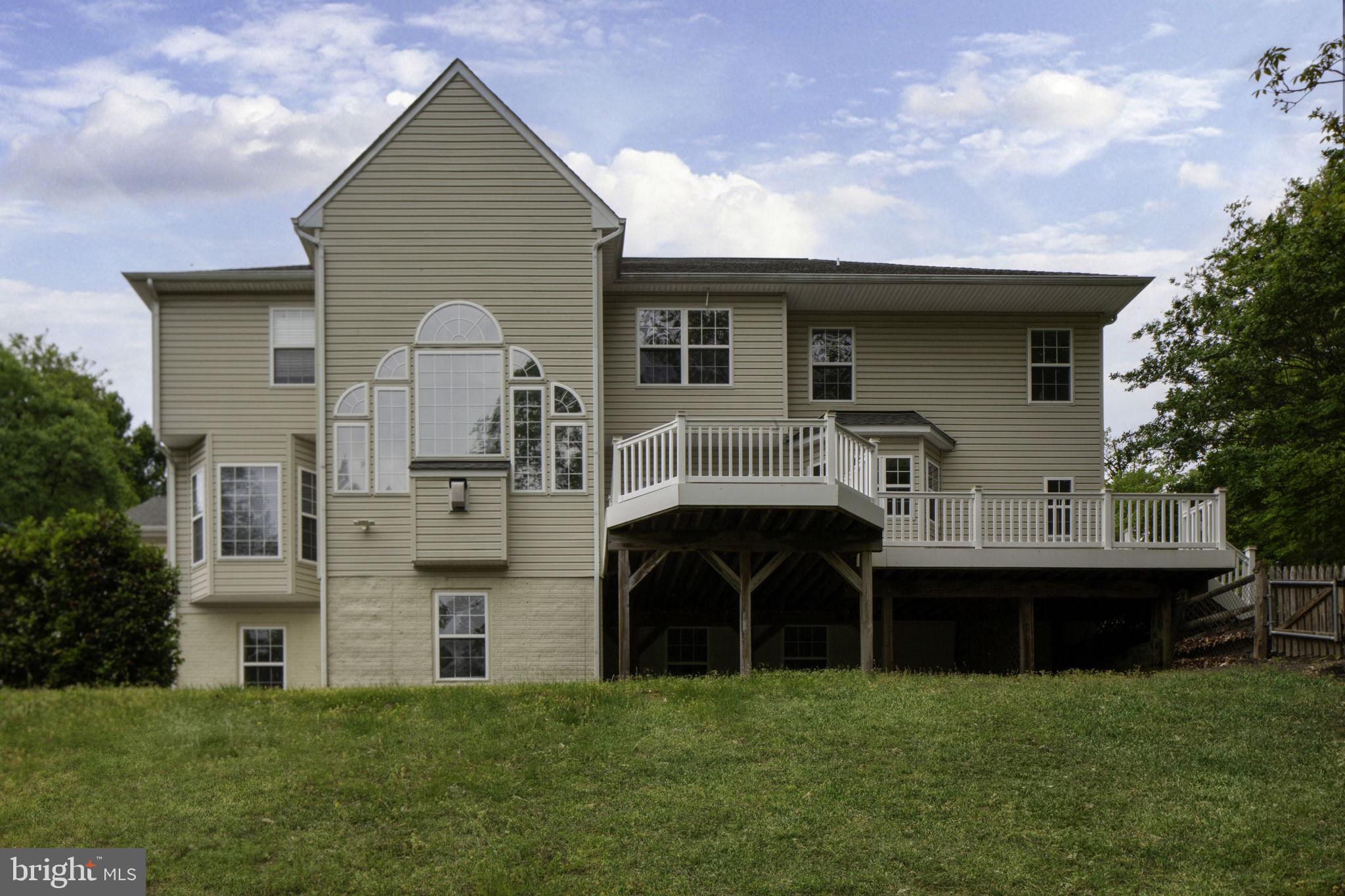 70 Sentinel Ridge Lane Stafford, VA 22554 - Photo 50 of 53 a front view of a house with a garden and trees