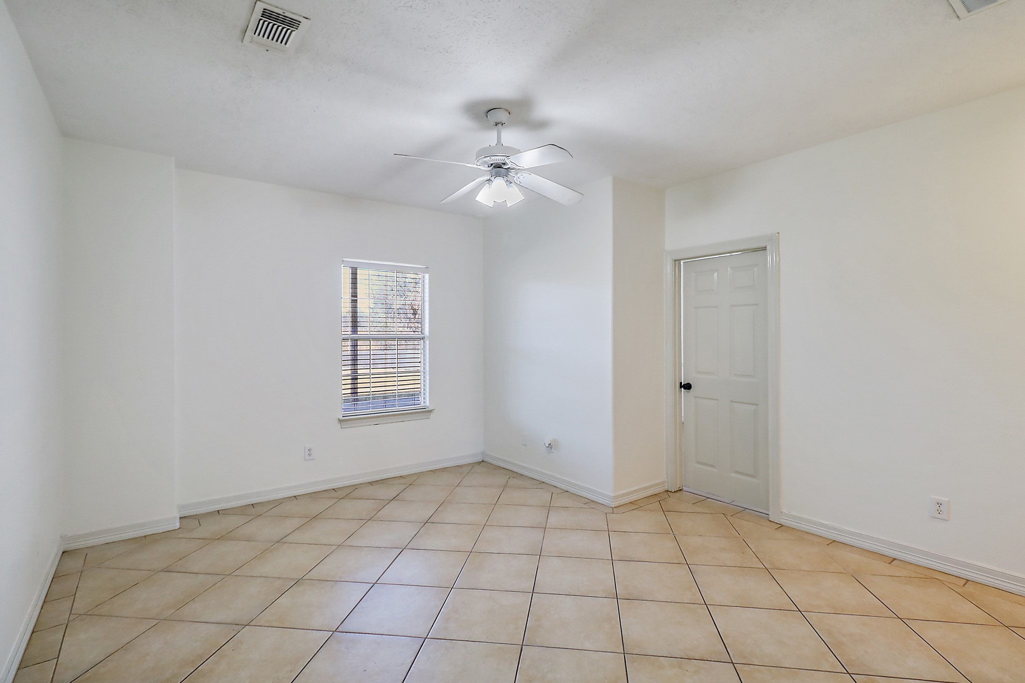 1306 Spring Branch Drive Baytown, TX 77523 - Photo 15 of 38 a view of an empty room with window and chandelier fan
