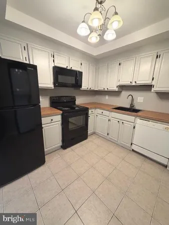 a kitchen with cabinets and stainless steel appliances