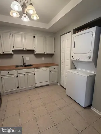 a kitchen with cabinets and white appliances