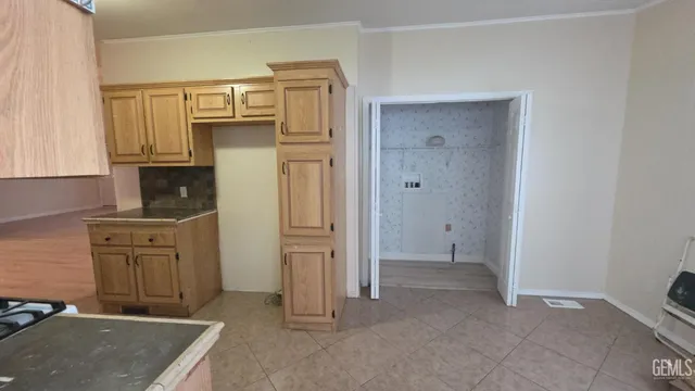 a view of kitchen with granite countertop cabinets and refrigerator