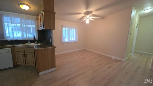 a kitchen with cabinets and window