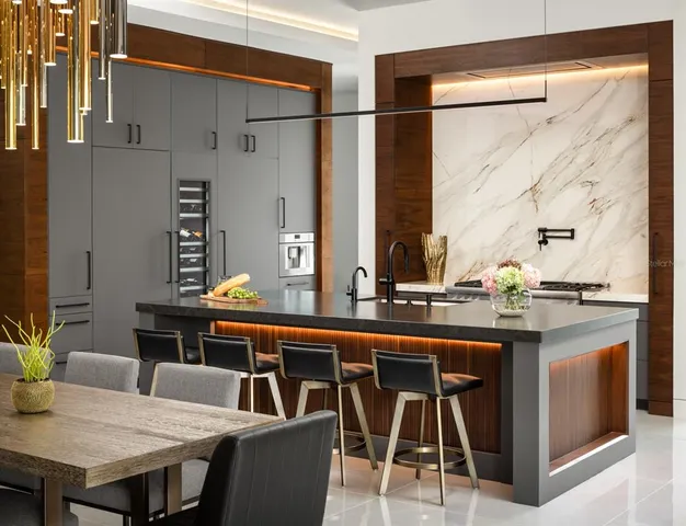 a dining table chairs next to a window