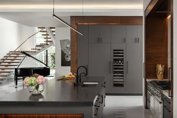 a dining room with furniture and a kitchen view