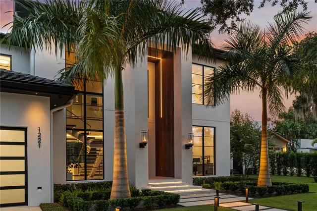 front view of a house with a palm plants