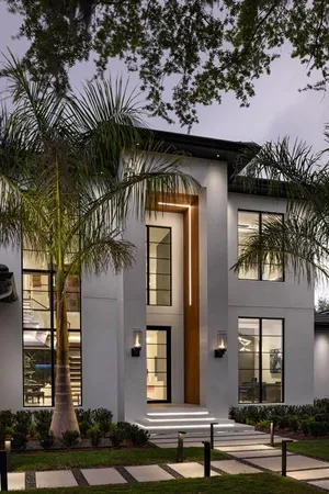 a front view of a house with a garden