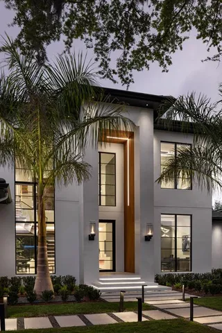 a front view of a house with a garden