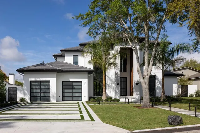 a front view of a house with a garden