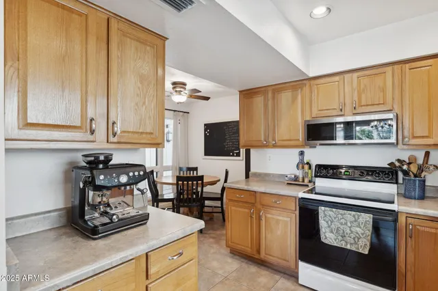 a kitchen with granite countertop a sink a stove and cabinets