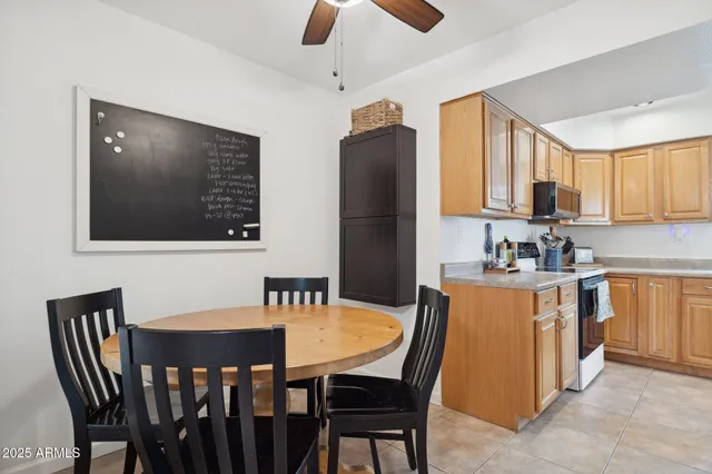 a kitchen with a sink refrigerator and cabinets