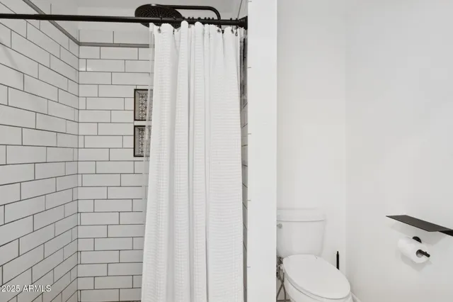 a bathroom with double vanity sinks and a mirror