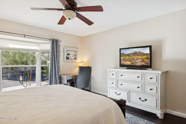 a bedroom with a bed and a window