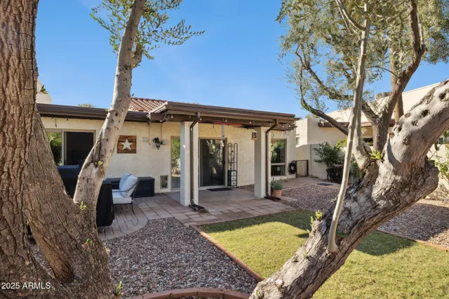 a view of a house with backyard and sitting area
