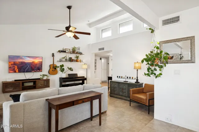 a living room with furniture and a chandelier