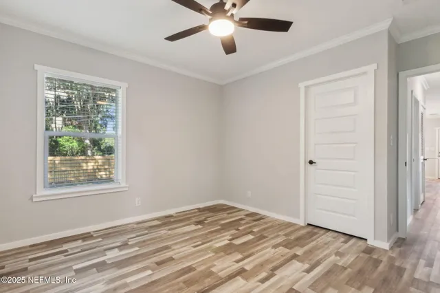 a view of a livingroom with a ceiling fan and window