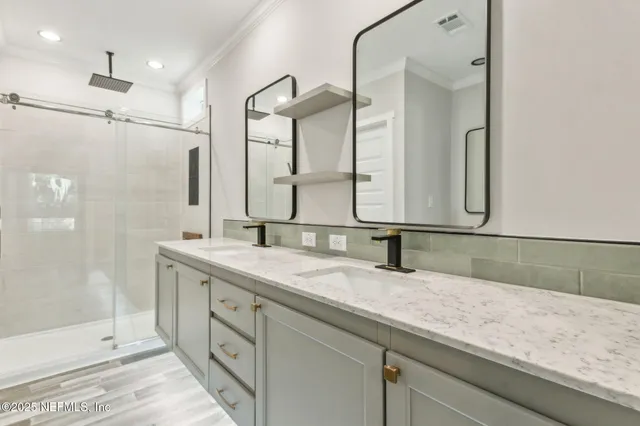 a bathroom with a double vanity sink mirror and double
