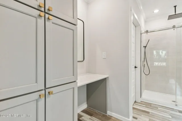 a bathroom with a shower and a glass door
