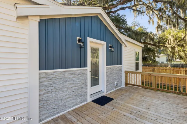 a view of a house with wooden fence