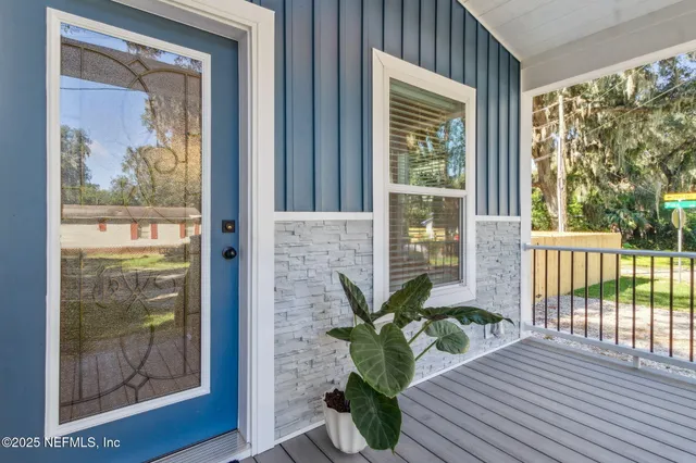 a view of a room with wooden floor and a window