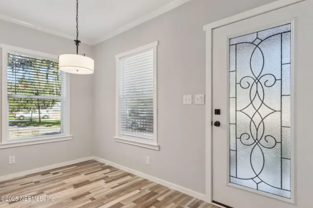a view of an entryway with wooden floor