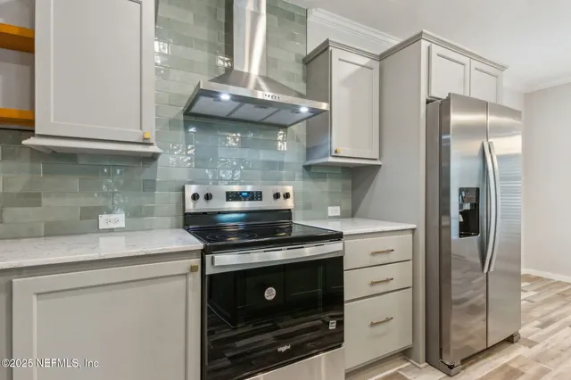 a kitchen with stainless steel appliances granite countertop a stove a refrigerator and a microwave