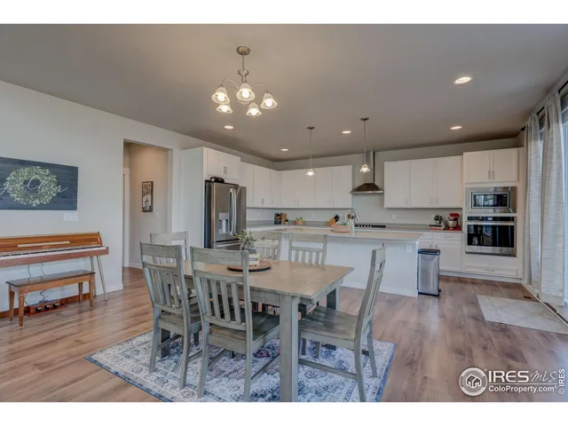 a open dining room with kitchen island furniture and wooden floor