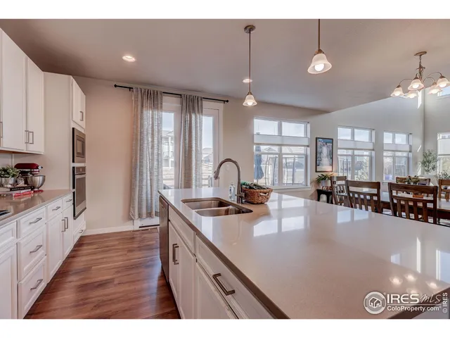 a open kitchen with stainless steel appliances granite countertop a sink refrigerator and cabinets