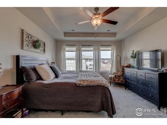 a bedroom with a bed dresser and a window