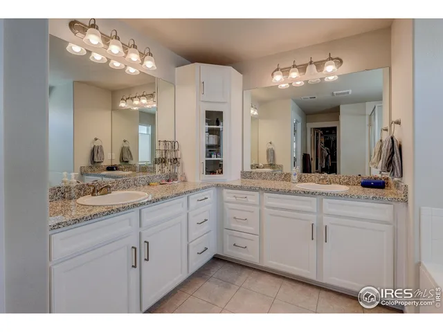 a bathroom with a sink vanity and a mirror