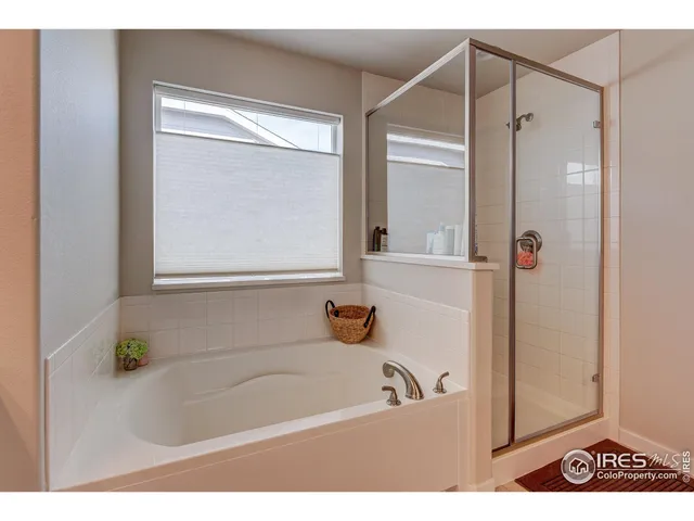 a bathroom with a tub a sink and a window