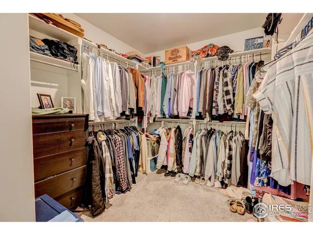 a view of walk in closet with clothes