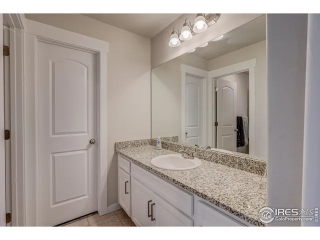 a bathroom with a sink vanity and a mirror