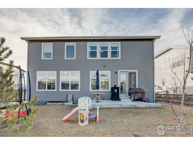 a wooden bench sitting in front of a building