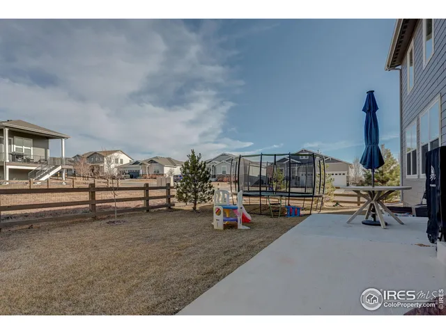 a backyard of a house with fireplace and retail shop
