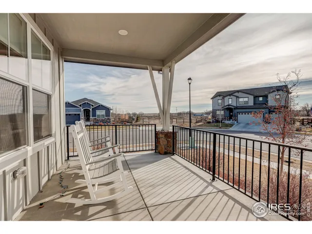 a view of a balcony with a floor to ceiling window and wooden floor