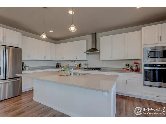a kitchen with stainless steel appliances granite countertop a sink refrigerator and microwave