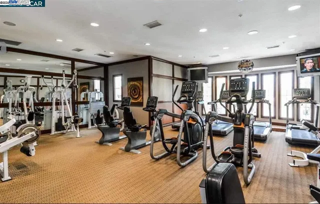 a living room with furniture a large window and a chandelier