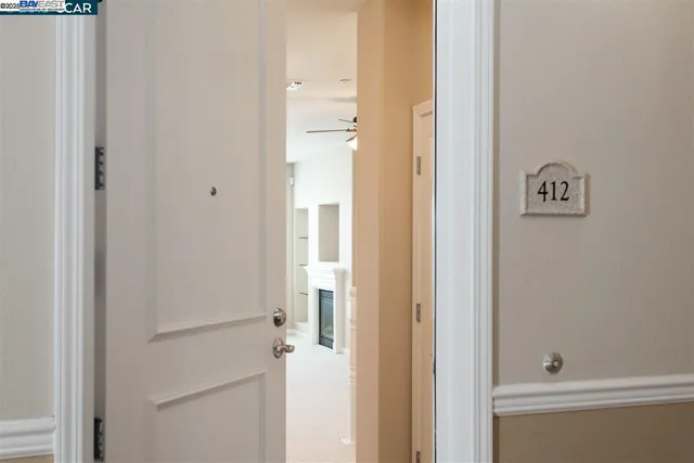 a living room with stainless steel appliances kitchen island a sink and a refrigerator