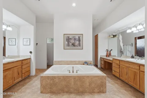 a spacious bedroom with a bed and a cabinets