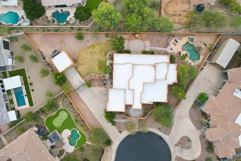 an aerial view of a house with a swimming pool