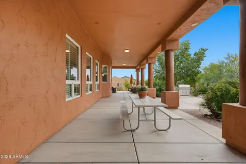 a view of a patio with table and chairs and potted plants