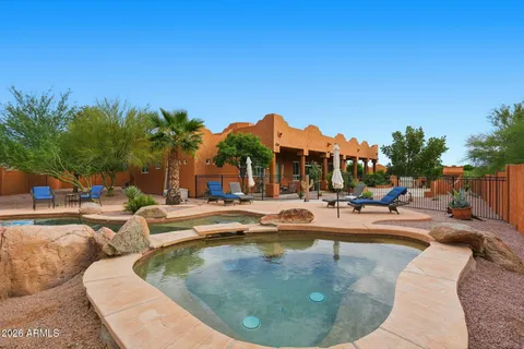 a view of a swimming pool with outdoor seating