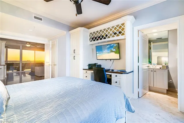 a large bedroom with a large bed and a large window