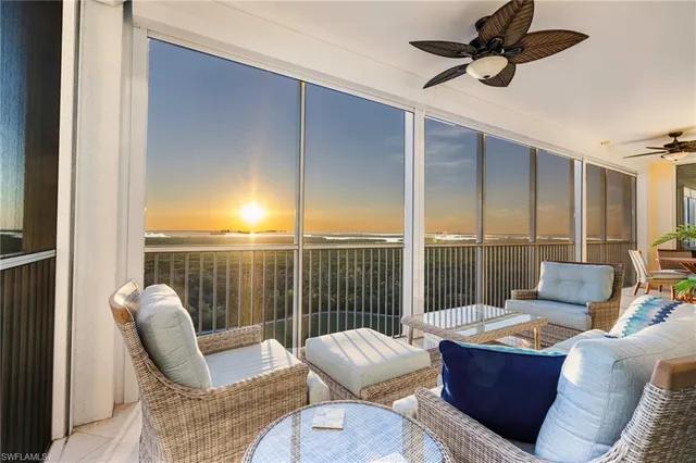 a living room with furniture and a floor to ceiling window