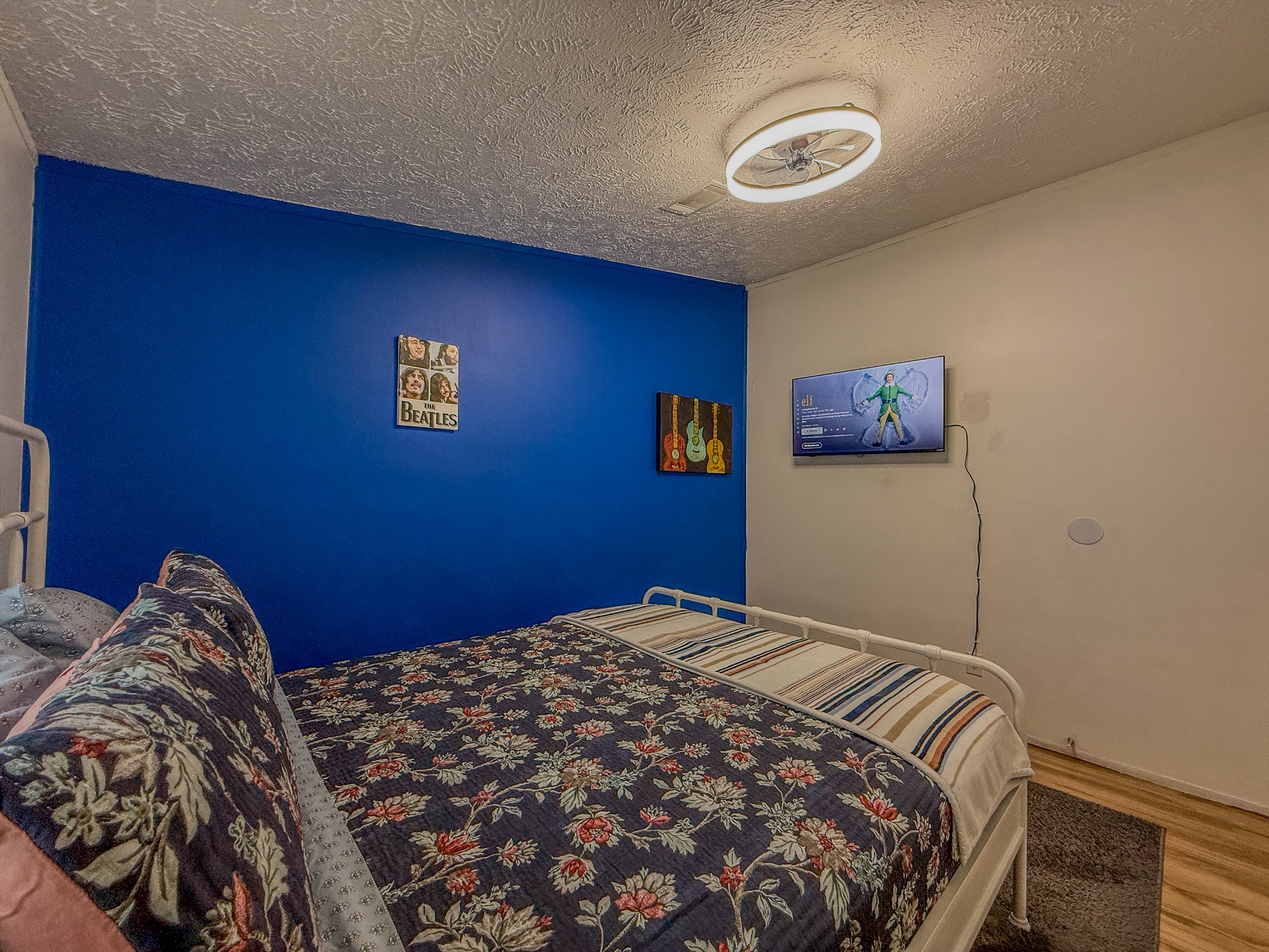 2015 Holly Street Austin, TX 78702 - Photo 16 of 24 An inviting bedroom features warm wood flooring and a modern ceiling fan, creating a comfortable retreat.