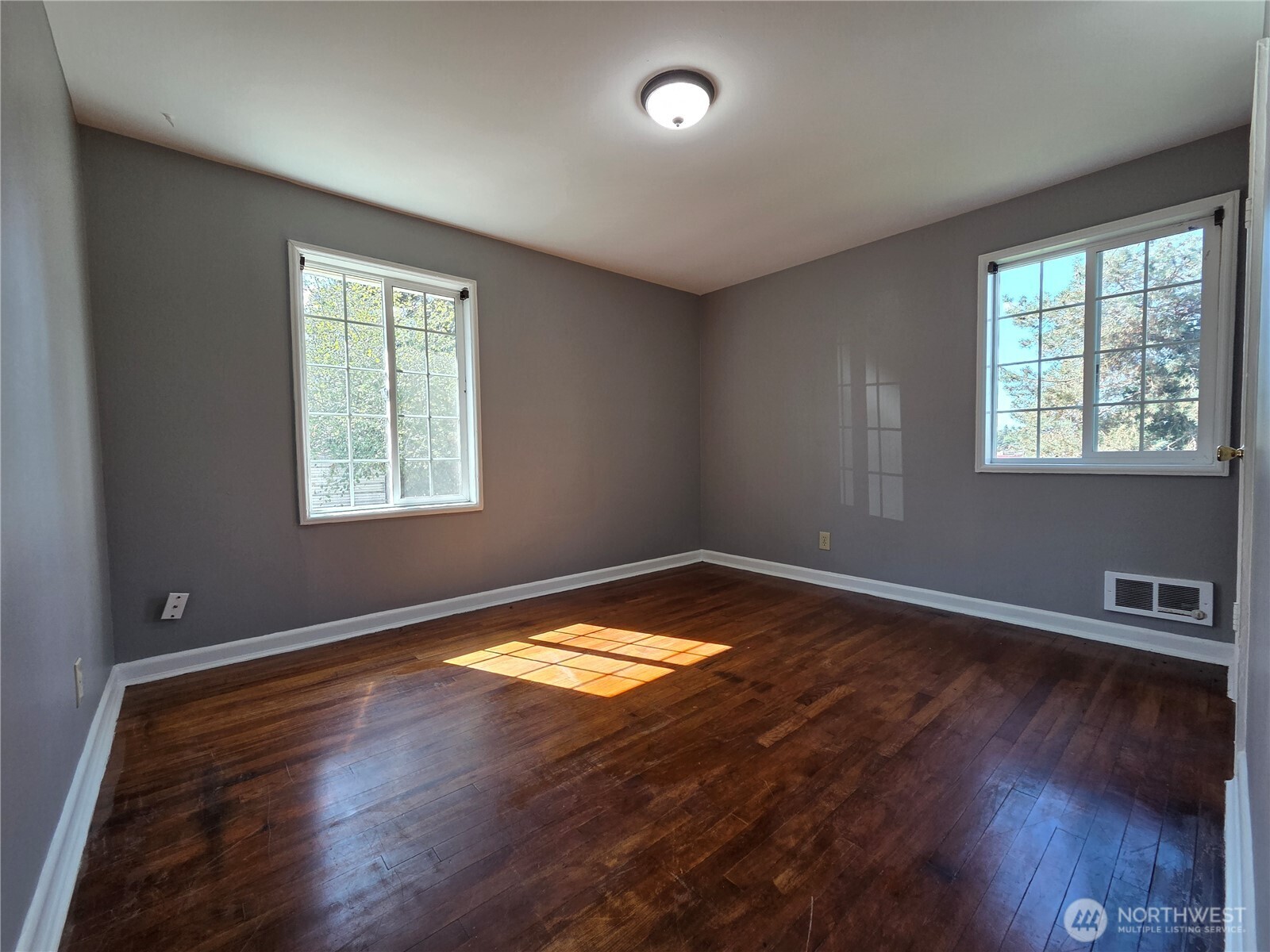 10603 12th Avenue Southwest Seattle, WA 98146 - Photo 7 of 14 a view of empty room with wooden floor and fan